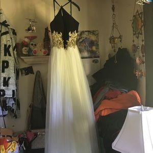 Black and white lace formal dress has gold design